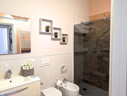 a bathroom with a shower and a toilet and a sink at Maison del Ducato Suite Correggio in Parma