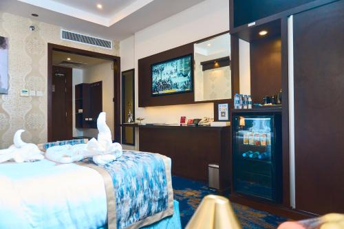 a hotel room with a bed and a drink refrigerator at Selat Al Bait Hotel in Makkah