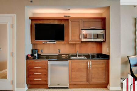 a kitchen with a sink and a microwave at MGM Signature-15-717 F1 Track & Strip View Balcony in Las Vegas