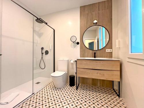 a bathroom with a toilet and a sink and a mirror at Soho Boutique Palillero in Cádiz