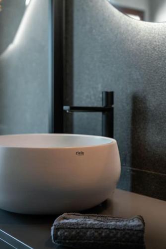 a bowl sitting on top of a table next to a chair at 1-bedroom design apartment with panoramic view in Mira