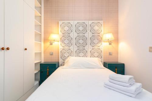 a bedroom with a bed with towels on it at PLAZA DE CASTILLA Apartments in Madrid