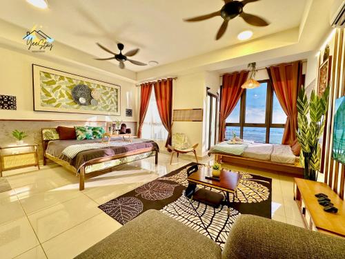 a bedroom with a bed and a couch and a table at SeaView PoolView CityView BaliResidence Video game 5minJonker in Melaka