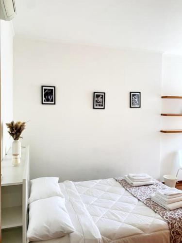 a white bedroom with a bed and a desk at MHOME APARTMENT - Roma in Rome