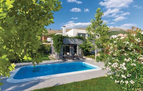 a swimming pool in the yard of a house at Villa Beganovic with private heated pool in Podstrana