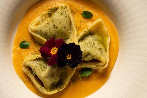 a white bowl filled with a bowl of soup with food at Rivoli Boutique Hotel in Florence