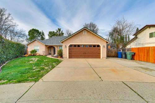 a house with a driveway with a brown garage at Pet-Friendly Redding Home with Spacious Patio in Redding