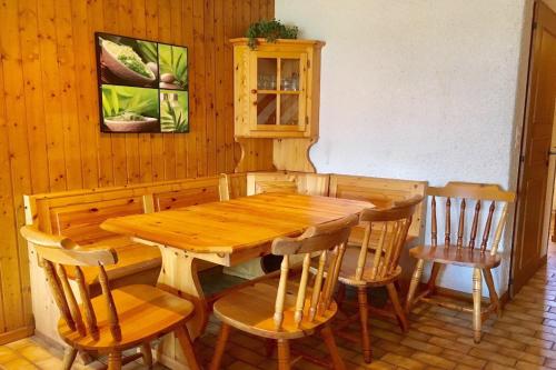 a wooden table and chairs in a room at Tourtereaux 223 in Verbier