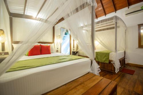 Giường trong phòng chung tại Jungle Shades villa - Habarana