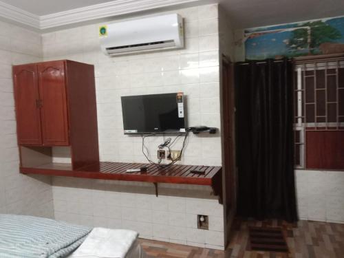 um quarto com uma televisão na parede em HOTEL SOWMYA INN em Ongole