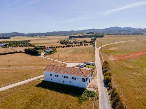 an aerial view of a white house in a field at I Ka Hale in Vila Nova de Milfontes