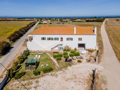 an aerial view of a white house with a yard at I Ka Hale in Vila Nova de Milfontes