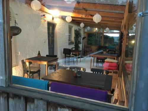 a window view of a restaurant with tables and chairs at Pension Elbkiosk in Kleinzadel