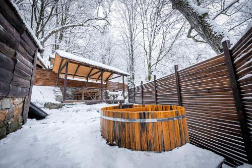 a wooden barrel in the snow next to a building at DiliJazz Hotel & Restaurant in Dilijan