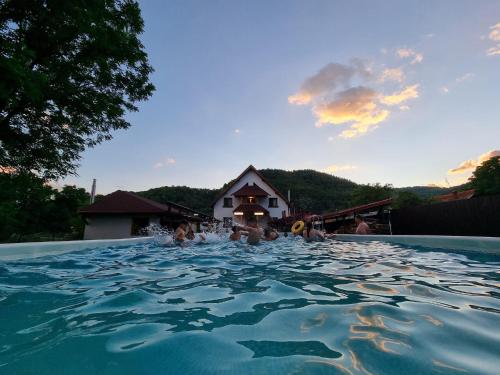 a group of people swimming in a swimming pool at CONACUL DE SUB MUNTE in Novaci-Străini