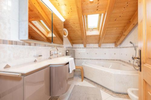 een badkamer met een bad en een wastafel bij Ferienwohnung Elisabeth in Reit im Winkl