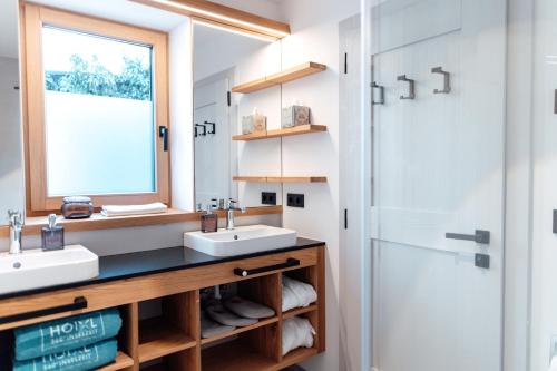 a bathroom with two sinks and a shower at Hoixl Gütl auf der Fraueninsel in Frauenchiemsee