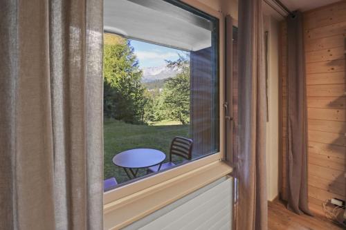 a window in a room with a table and a view at Magnifique studio avec terrasse au centre in Crans-Montana