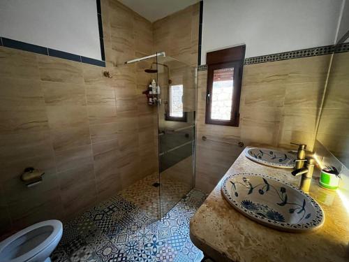 a bathroom with two sinks and a shower at Cortijo Las Pilares in Granada