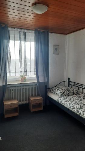 a bedroom with a bed and a window at Unterkunft A.Lambrecht in Oberhausen
