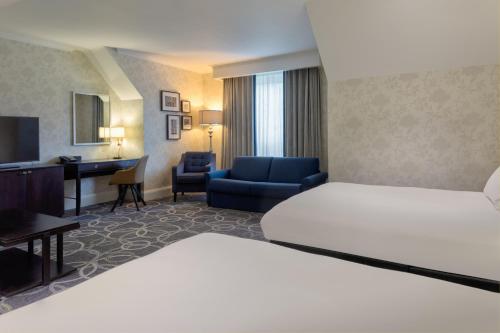 a hotel room with a bed and a desk at DoubleTree by Hilton St. Anne's Manor in Bracknell