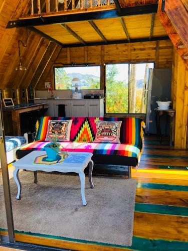 a living room with a couch and a table at Casa Índigo Tabio in Tabio