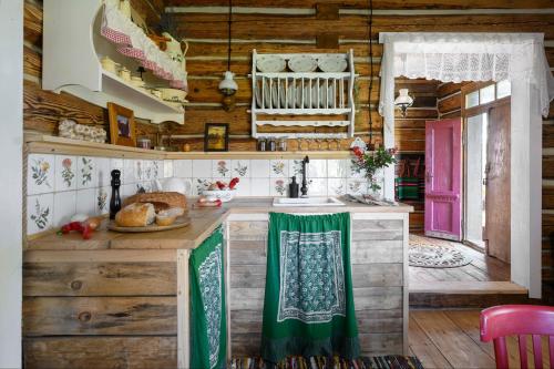 a kitchen with wooden walls and a counter with a sink at WsiaMać in Odrzykoń