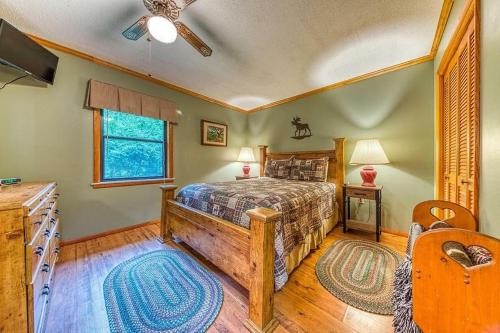 a bedroom with a bed and a ceiling fan at Lazy Creek Retreat in Gatlinburg