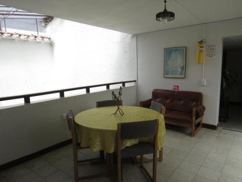 a dining room with a table and a chair at Hotel Tahami in Sonsón