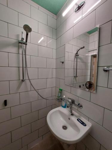 a white bathroom with a sink and a mirror at Студио Тони in Burgas