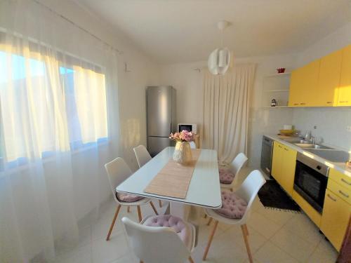 a kitchen with a table and chairs in a kitchen at Villa Almond near Omis, private pool in Tugare