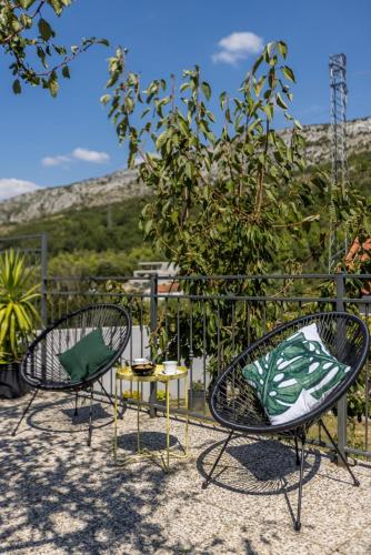 two chairs and a table in front of a fence at Villa Almond near Omis, private pool in Tugare