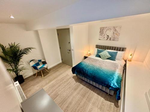a bedroom with a bed and a chair in it at BL 1 Bedroom Apartment, Town Centre, Secure gated parking option, Modern, fresh and spacious living, Netflix ready TV, Wifi in Wellingborough