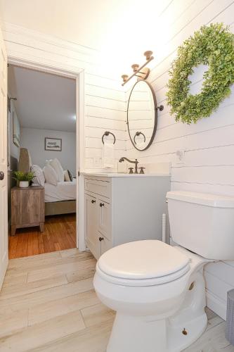 a bathroom with a white toilet and a sink at Walk2Beach, HotTub, FirePit, PetsOk in Dennis