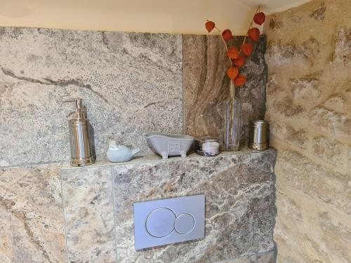 a stone counter with two rings on it at Ferme de Tayac - Charme avec Pool in Les Eyzies-de-Tayac