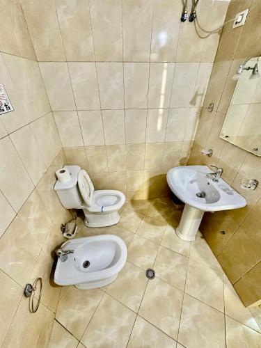 a bathroom with a toilet and a sink at Eno’s Apartment 2 in Vlorë