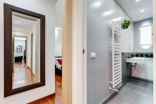 a bathroom with a mirror and a sink at BDC - Fancy 2-Bdr Apt @Vatican in Rome