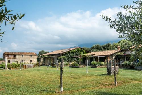 a house with a fence in front of it at Olimagio Farm Stay with animals and 25m pool, beach at cycling distance in Pietrasanta