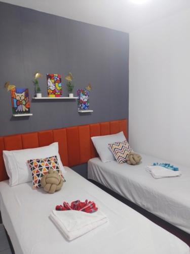 a room with two beds with stuffed animals on them at Apartamento Inteiro São Luís in São-José-do-Ribamar