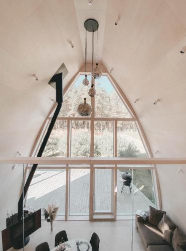 an arched window in a living room with a large window at CIPRESES in Engure