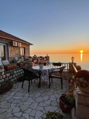 a patio with a table and chairs and the ocean at Apartments Antigona Old Town in Ulcinj