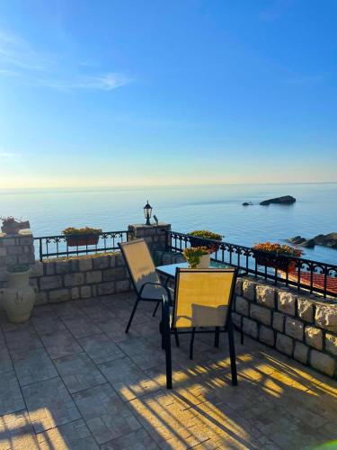 a patio with a table and chairs and the ocean at Apartments Antigona Old Town in Ulcinj