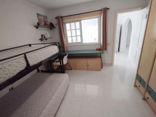 a room with two bunk beds and a window at Tango House in Arona