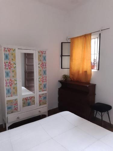 a bedroom with a bed and a dresser and a window at Lo de Gavy in Concepción del Uruguay