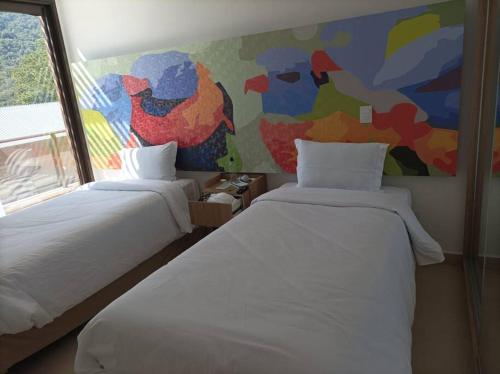 1 dormitorio con 2 camas y un cuadro en la pared en Apartamento no Capivai Eco Resort Residence en Represa Capivari