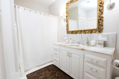 a white bathroom with a mirror and a sink at Clifton House - Panorama - Queen Suite, Sleeps 4, River Views in Natchez