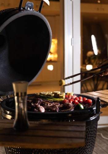 a pan of vegetables on a table with a spatula at CIPRESES in Engure