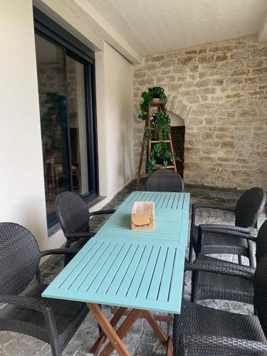 a blue table and chairs on a patio at MAISON AVEC JACUZZI in Bourgoin