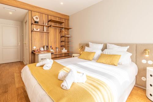 a bedroom with a large bed with towels on it at La Maison De Blanche in Bordeaux