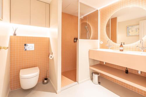 a bathroom with a toilet and a sink at La Maison De Blanche in Bordeaux